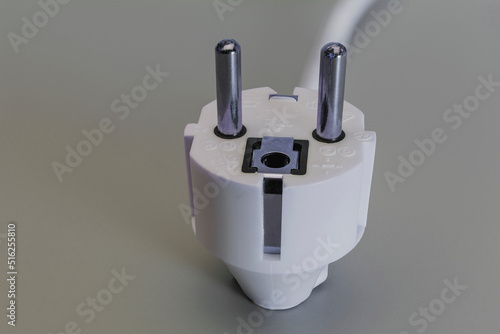 EU plug on a gray background. Home electrician. Close-up. Full focus. copy space.