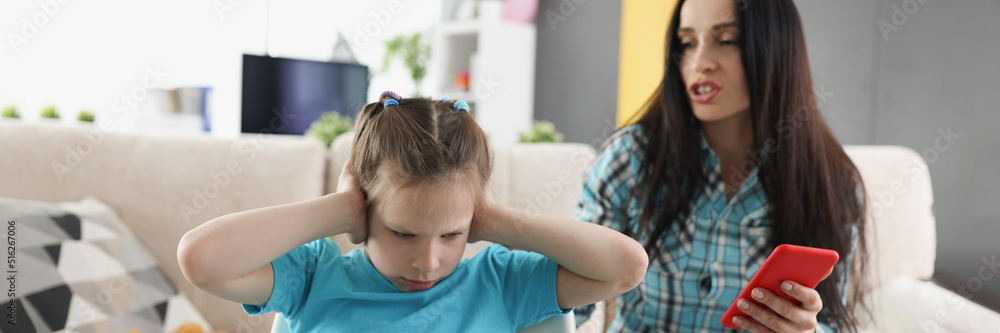 Millennial mother scream on child, kid close ears with hands Millennial mother scream on child, kid close ears with hands