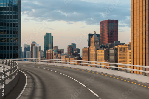 Empty urban asphalt road exterior with city buildings background. New modern highway concrete construction. Concept of way to success. Transportation logistic industry fast delivery. Chicago. USA.