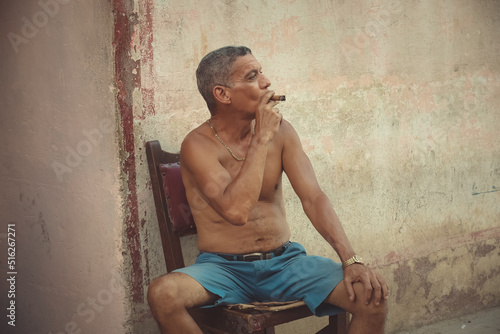 Old man with a big cigar on the Havana street © AJITH.A