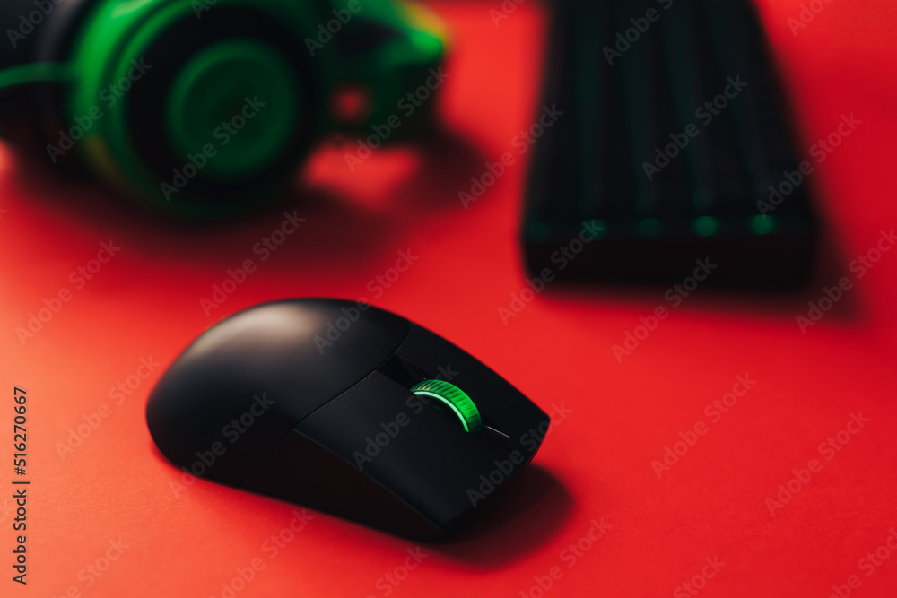 Gaming wireless accessories with green backlight on red background. Gaming wireless accessories with green backlight on red background.