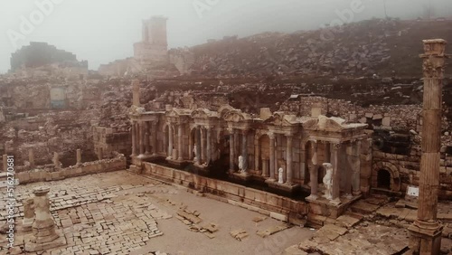 Partially reconstructed Nymphaeum building at ruins of ancient city of Sagalassos on foggy winter day, Turkey photo