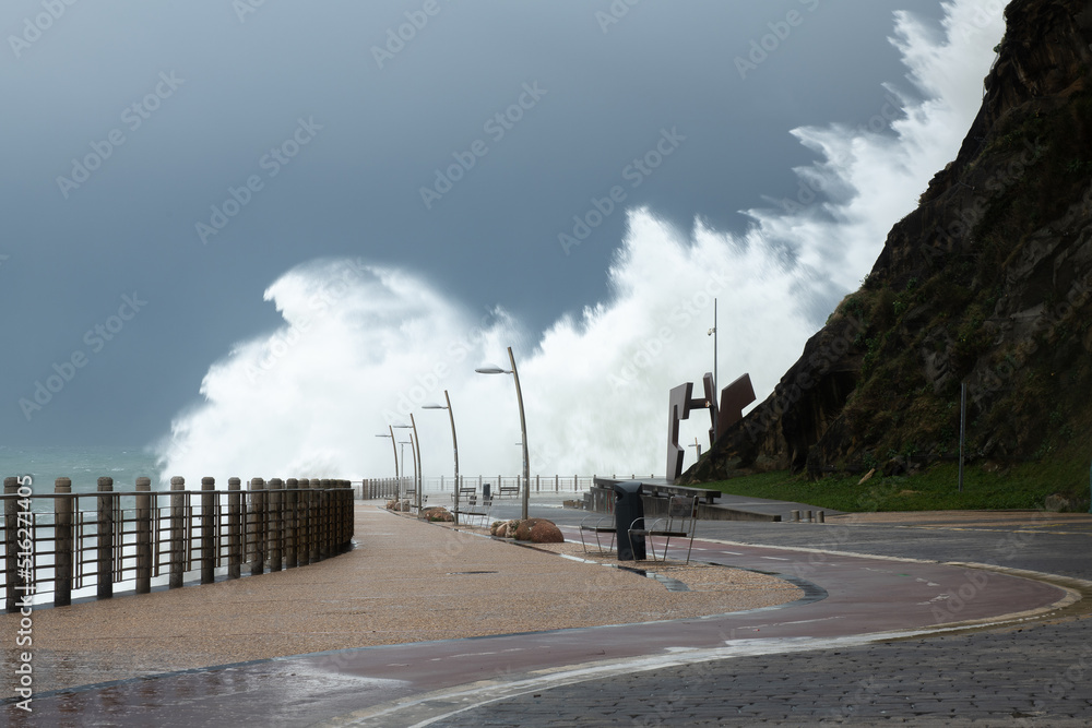 Fototapeta premium Waves breaking on the New Promenade of San Sebastian during a storm, Spain