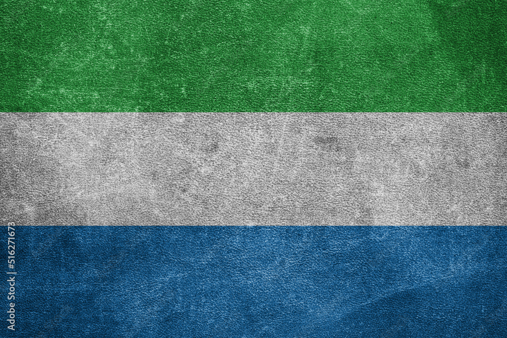 Old leather shabby background in colors of national flag. Sierra Leone