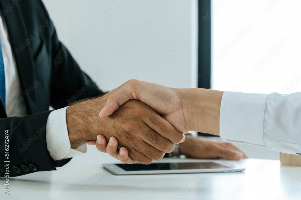 Partnership. two business people shaking hand after business signing contract in meeting room at company office, job interview, investor, success, negotiation, partnership, teamwork, financial concept