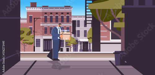 depressed businessman in despair dismissed business man with things walking city street unemployment crisis jobless