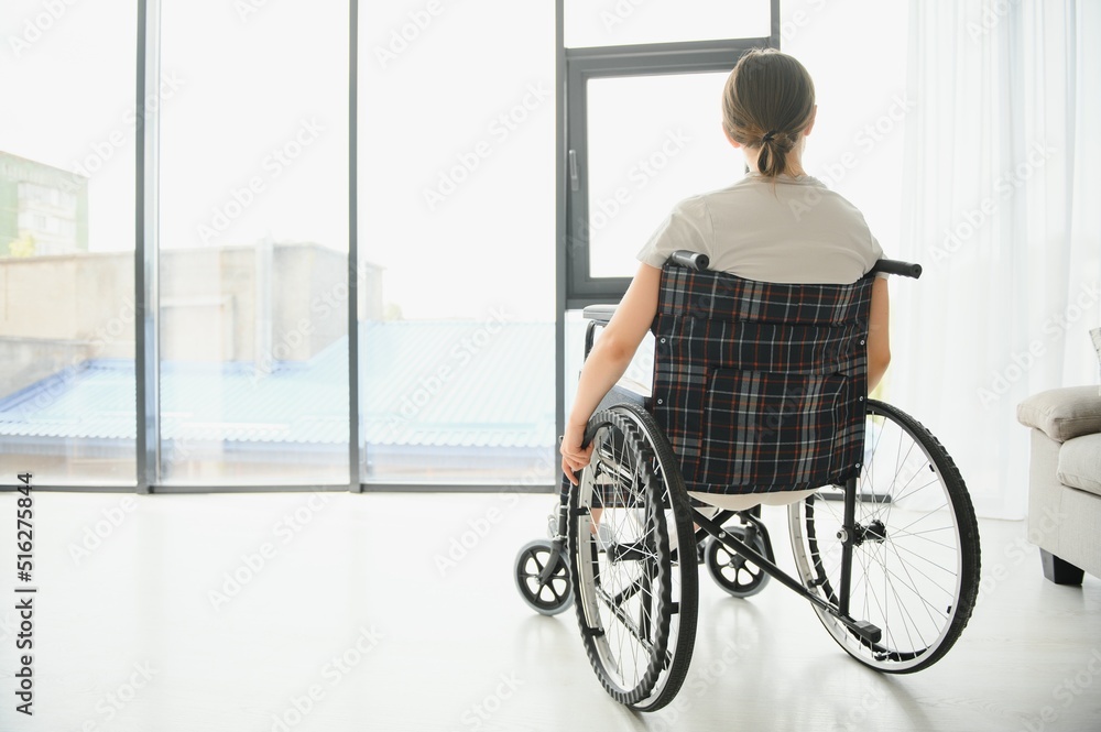 Young woman in wheelchair at home