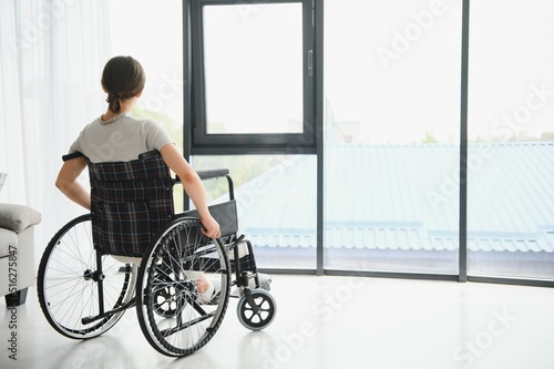 Canvastavla Young woman in wheelchair at home