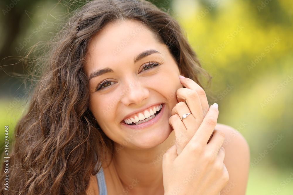 Happy bride with perfect smile showing engagement ring