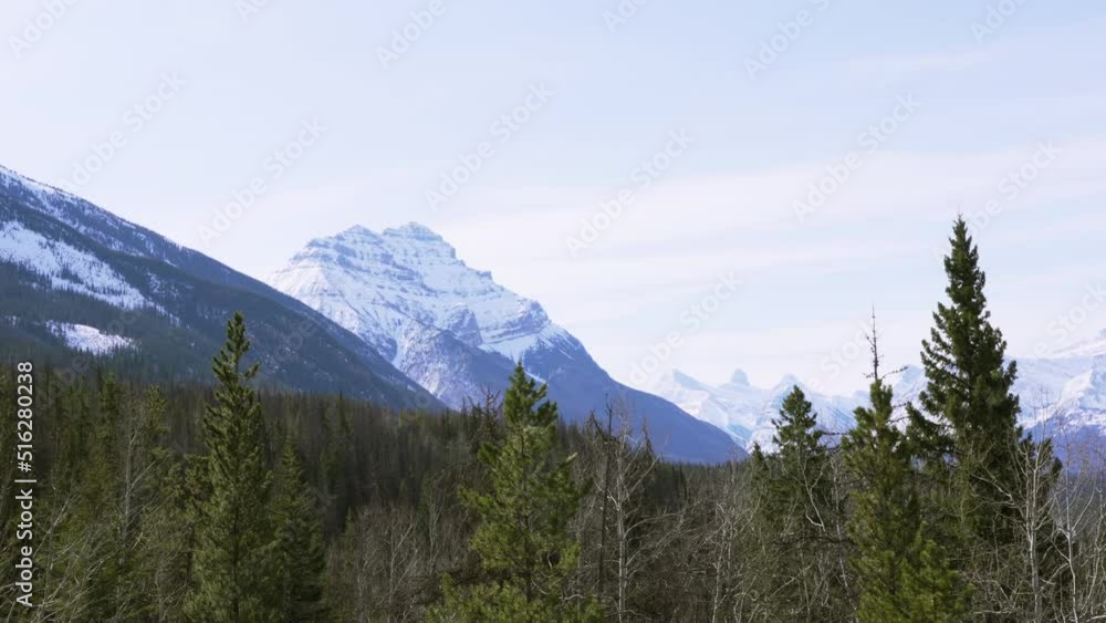 A slow pan right shot of forests amongst the Rocky Mountains. A slow pan right shot of forests amongst the Rocky Mountains.