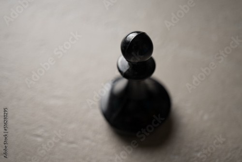 Chess piece Pawn close-up on a light background, the concept of an idea, promotion, success