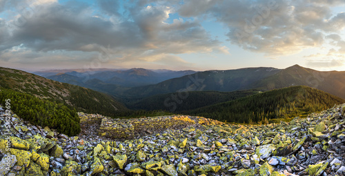 Obraz na plátně Summer evening Carpathian mountain stony slope panoramic view in last sunset sunlight