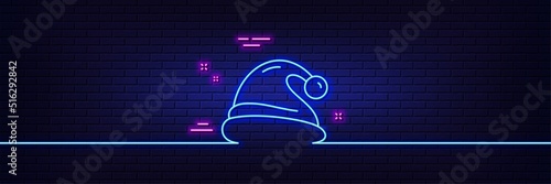 Neon light glow effect. Santa hat line icon. Christmas or New year sign. Claus symbol. 3d line neon glow icon. Brick wall banner. Santa hat outline. Vector