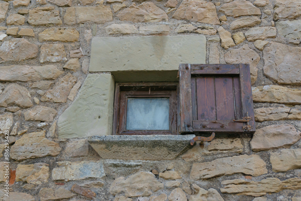 Stone house with a small wooden door window