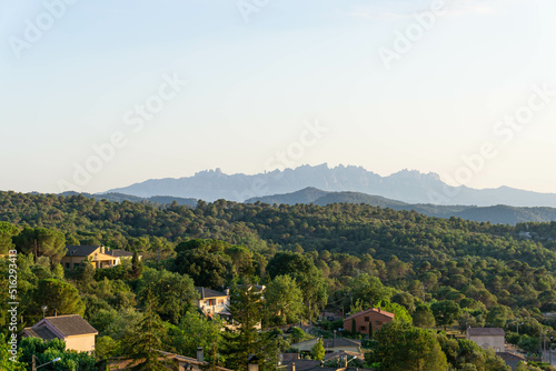 View of the houses in the forest of the town of Talamanca in Bages and the mountains of Montserrat in the background © Joan Manel Moreno