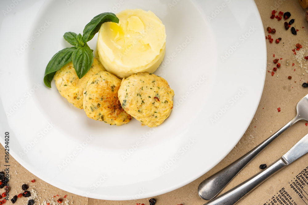 mashed potatoes with cutlets decorated with basil leaves in a white plate macro photo
mashed potatoes with cutlets decorated with basil leaves in a white plate macro photo