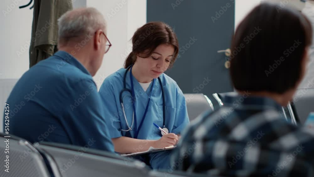 Medical assistant doing consultation with senior patient in waiting area, sitting in hospital reception lobby. Female nurse talking to retired person about disease diagnosis and healthcare. Close up. Medical assistant doing consultation with senior patient in waiting area, sitting in hospital reception lobby. Female nurse talking to retired person about disease diagnosis and healthcare. Close up.