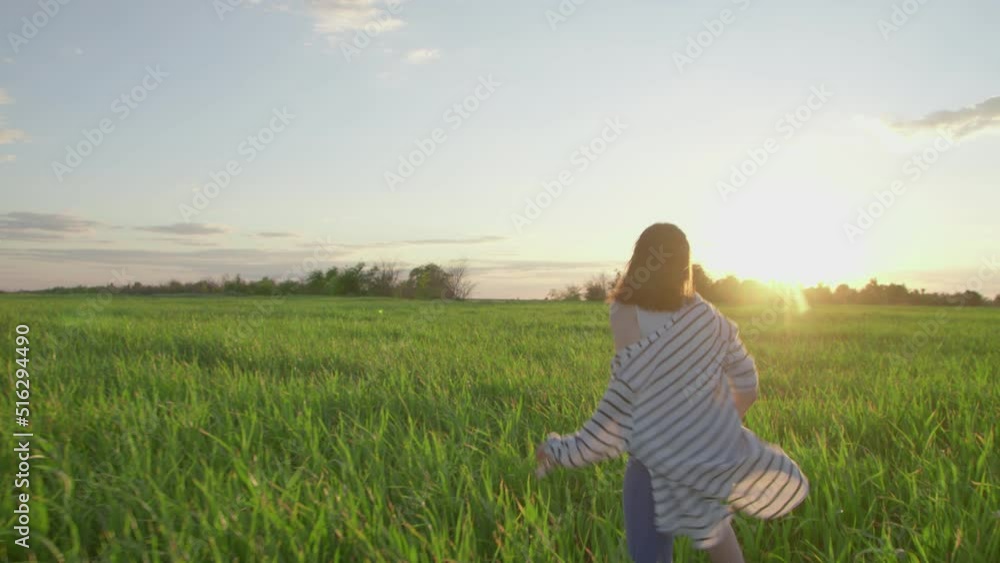 4K. A happy girl runs merrily around the field. 4K. A happy girl runs merrily around the field.