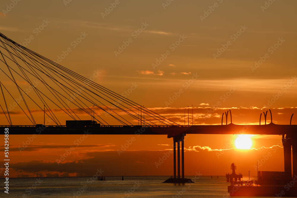 View of the span of the cable-stayed bridge against the backdrop of the setting sun.