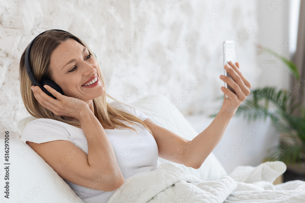Happy young lady having video chat with lover Happy young lady having video chat with lover