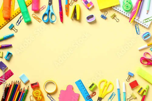 Back to school concept. Frame made of colorful school supplies on yellow background. Flat lay, top view, copy space.