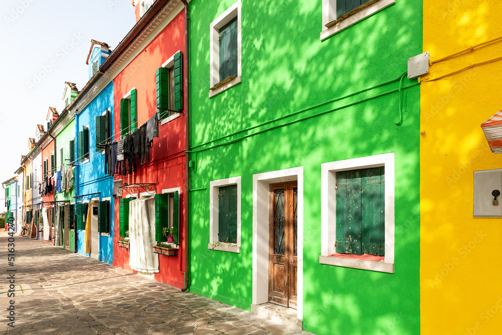 Street with colorful houses on the island of Burano . Italy.