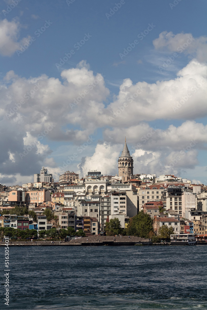 View of Galata tower and Beyoglu district on the European side of Istanbul. It is a sunny summer day.