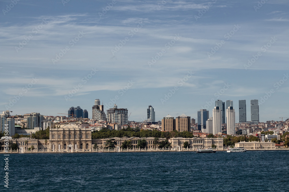 Fototapeta premium View of historical Dolmabahce Palace by Bosphorus and European side of Istanbul. It is a sunny summer day.