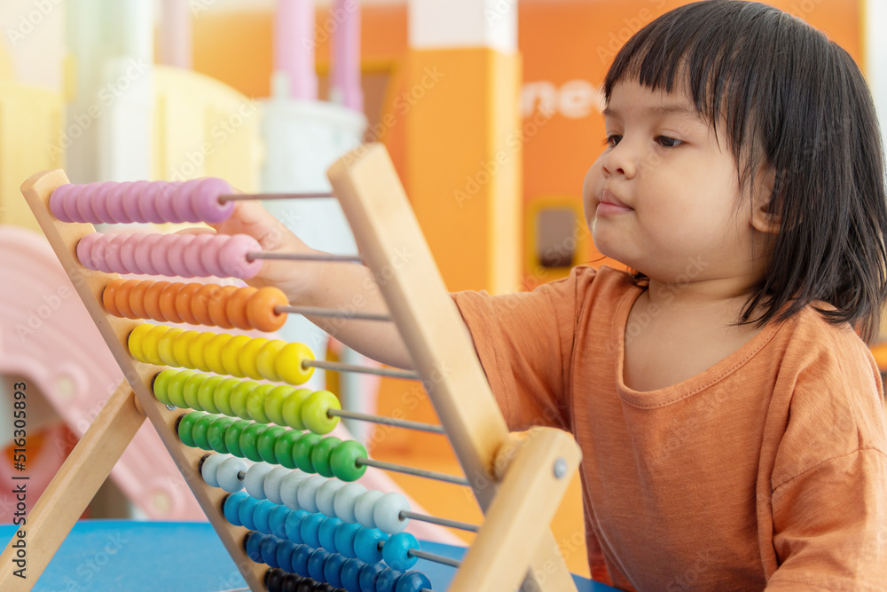 Kids intend learn from play with colorful wooden toy on table desk at home. Preschool young girl concentrating with educational block in recess term back to school Children at home or daycare child. Kids intend learn from play with colorful wooden toy on table desk at home. Preschool young girl concentrating with educational block in recess term back to school Children at home or daycare child.