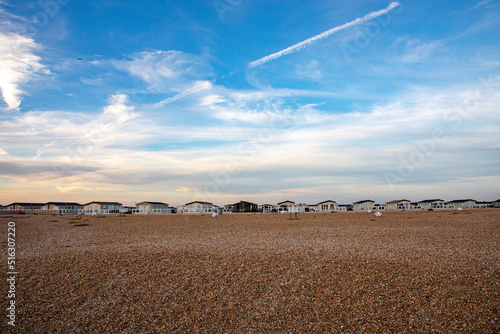 Mobile homes in Selsey at shingle beach in sunset, golden hour light photo