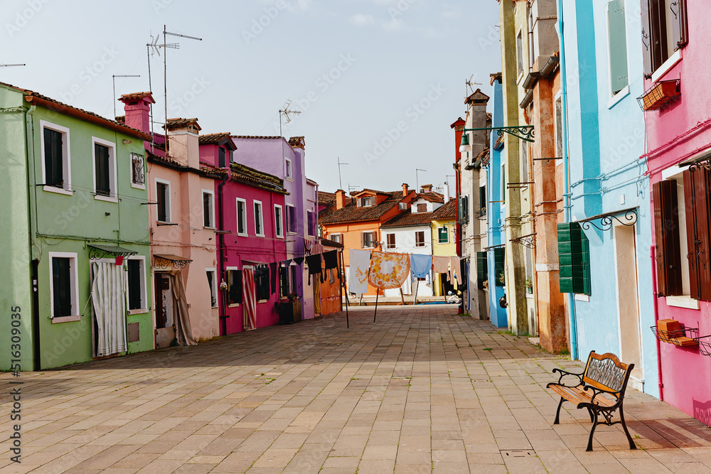 Street with colorful houses on the island of Burano in the morning. Italy.