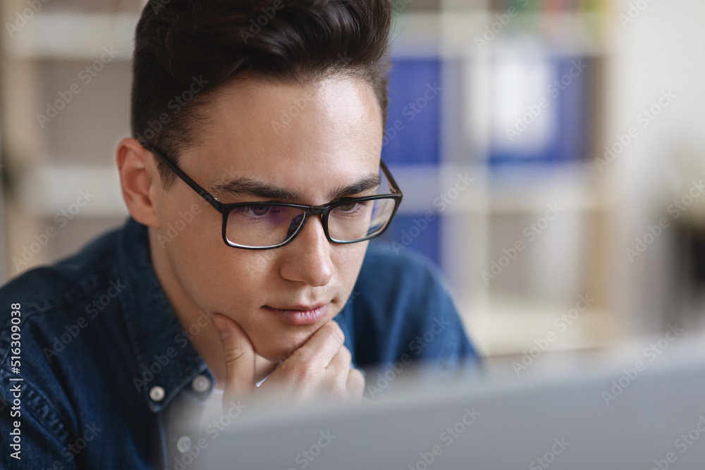 Portrait Of Young Handsome Guy In Eyeglasses Looking At Computer Screen Portrait Of Young Handsome Guy In Eyeglasses Looking At Computer Screen