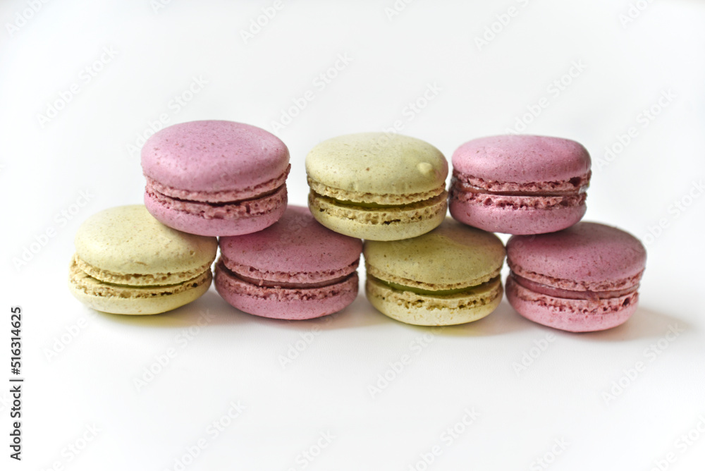 Delicious multicolored almond cookies isolated on a white background. Sweet multicolored macaroons. Delicious multicolored almond cookies isolated on a white background. Sweet multicolored macaroons.