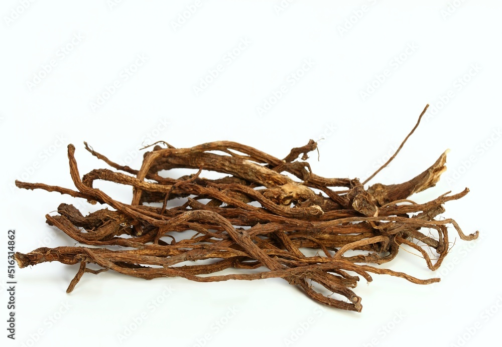 Obraz premium Organic dried roots of dandelion, Taraxacum officinale, traditional herbal medicine. Roots prepared for making tinctures and medicine on the white background.