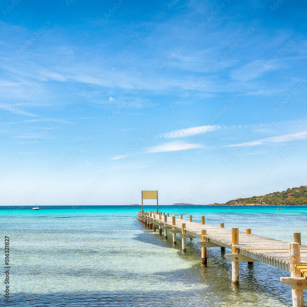 Astonishing landscape with wooden pier on Santa Giulia beach.