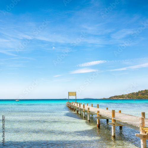 Astonishing landscape with wooden pier on Santa Giulia beach.