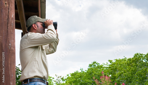 Photos Forest ranger watches from a high observation platform the presence of possible