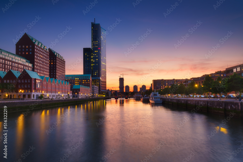 Rotterdam, Netherlands. View of the city center. Cove and pier for boats and ships. Panoramic view. Cityscape in the evening. Skyscrapers and buildings.