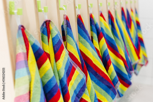 Colorful towels hang near the washbasins in kindergartens schools swimming pools