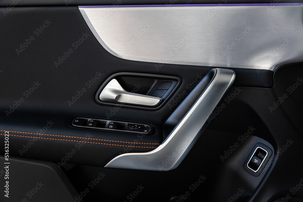 luxury door in a modern expensive car with ambient lighting and seat adjustments