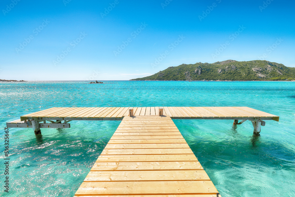 Amazing landscape with wooden pier on Santa Giulia beach.
