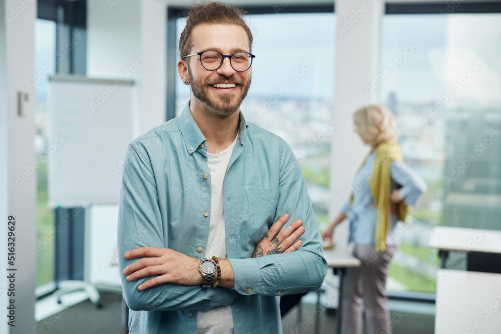 Portrait of a young teacher posing in a classroom. Portrait of a young teacher posing in a classroom.