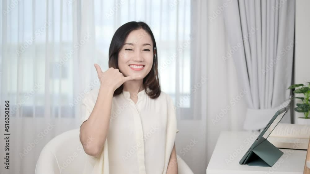 Asian girl greets the camera telling her friends to call us. Asian girl greets the camera telling her friends to call us.