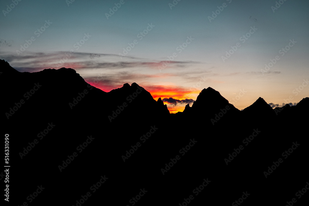 Red sunset in the high alpine mountains in summer