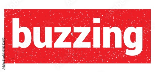 buzzing text written on red stamp sign.