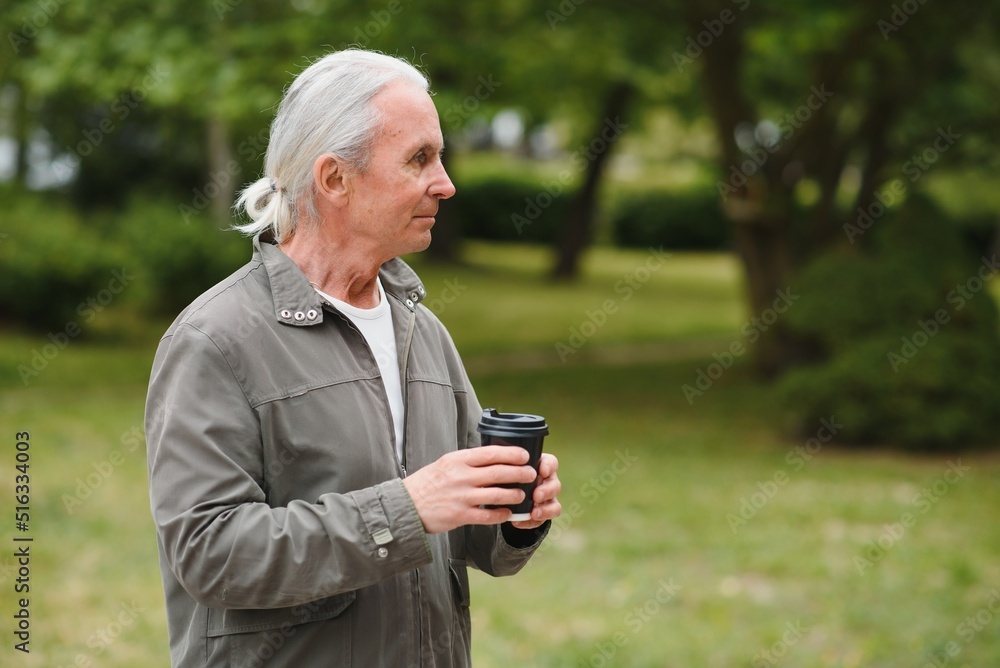 Senior man in stylish outfit holding cup of coffee. Senior man in stylish outfit holding cup of coffee.