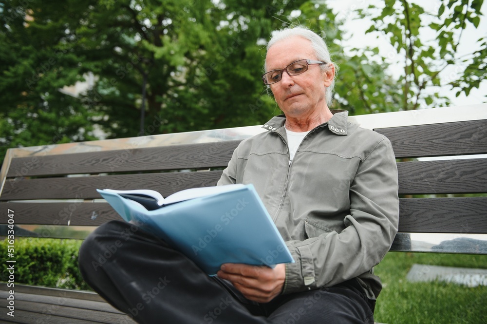 Old gray-haired man rest on the bench in summer park Old gray-haired man rest on the bench in summer park