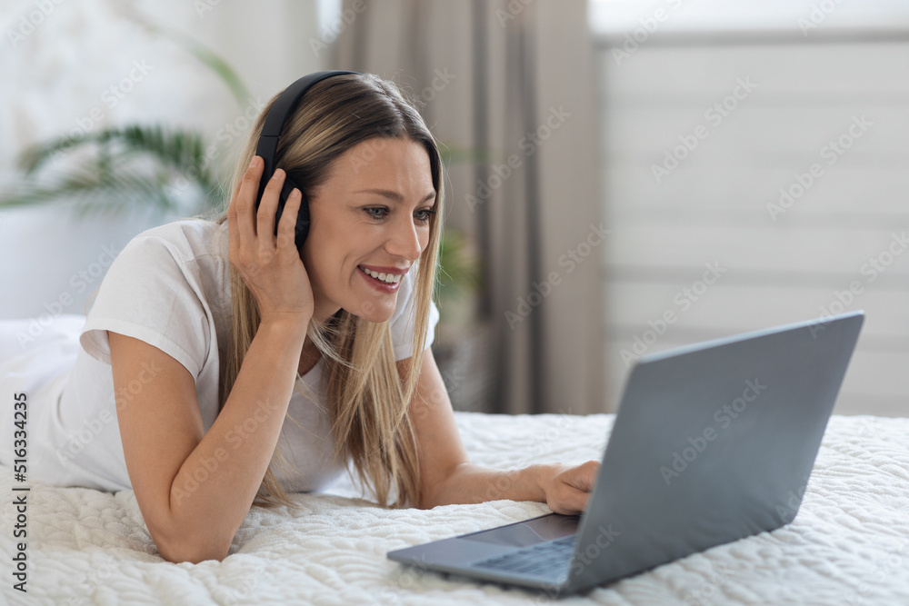 relaxed young lady watching movie online, using computer relaxed young lady watching movie online, using computer