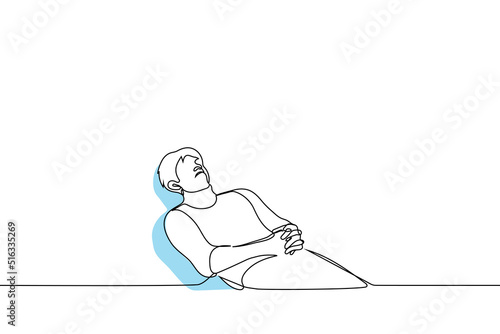 man lies tensely in a chair at a doctor's appointment - one line drawing vector. concept adult is afraid of the dentist, dentist appointment