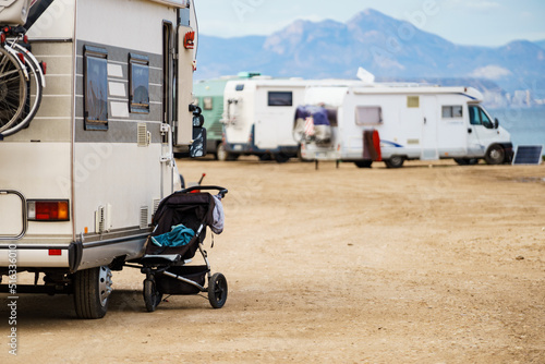 Photo Baby stroller at caravan outdoors on beach.